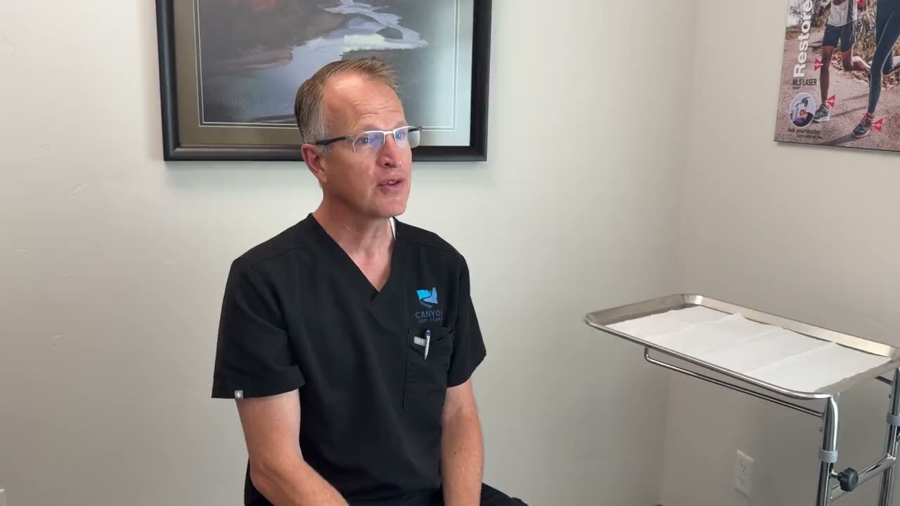 Dr. Pilling talking with a patient in the exam room